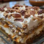 Delight in layers of creamy goodness with Pecan Pie Lasagna! A no-bake dessert with pecan, caramel, and cream cheese.